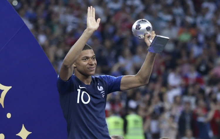 Kylian Mbappe of France receives the FIFA best young player award during the trophy ceremony following the 2018 FIFA World Cup Russia Final between France and Croatia at Luzhniki Stadium on July 15, 2018 in Moscow, Russia.