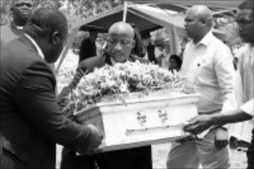 VICTIM: The coffin of three-month-old Keditlhotse Moiphithi is lowered at Swartruggens in the North West, on Saturday. Pic. 26/01/2008. © Unknown
