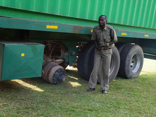 Tigoni police boss John Bosco Mulei yesterday inspects a trailer whose wheel killed a man / GEORGE MUGO
