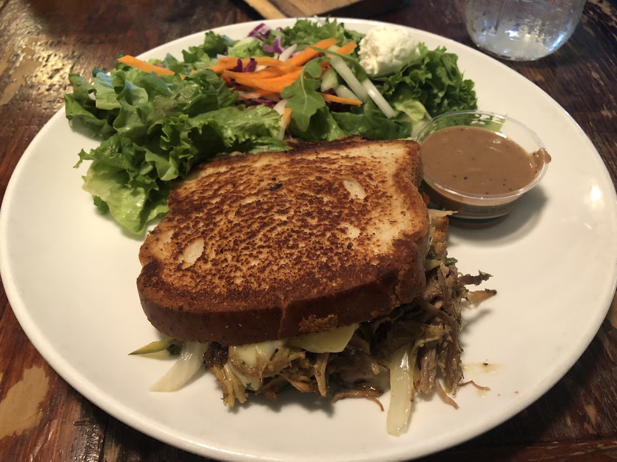 Bay of pigs sandwich on gluten free bread with a side salad.