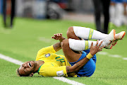 Neymar  screams in pain  after being fouled. The writer says  his antics are so popular   kids are now encouraged to roll on the ground during play to feign injury. 