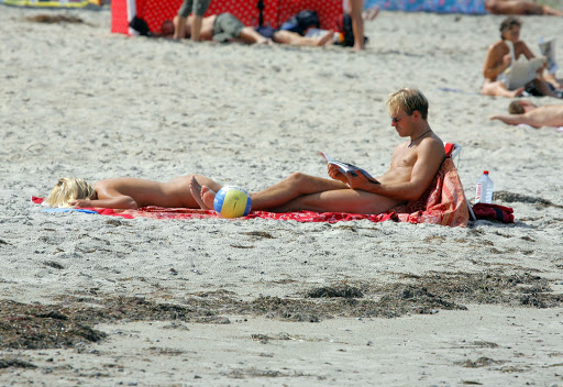 A couple sunbathes at Warnemuende nude beach in Rostock, Germany, Saturday, August 19, 2006. As many as 12 million Germans, who go to nude beaches at least once a year, according to Wolfgang Weinreich, the head of the International Naturist Federation, may think the same as it is becoming increasingly difficult to find a nude, or so-called FKK, beach. More than a third of them in the former East have disappeared since German reunification in 1990, said Horst Barthel, deputy head of the DFK German Naturism Federation in East Germany.