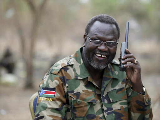 A file photo of South Sudan's rebel leader Riek Machar talks on the phone in his field office in a rebel-controlled territory in Jonglei State, South Sudan, February 1, 2014. /REUTERS