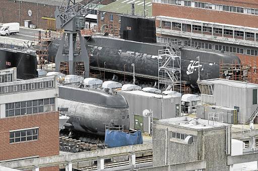SA Navy submarines in the dry dock at Simon's Town Naval Base. S102, rear, is in for routine maintenance, while S103, front, apparently hit the ocean floor, hence the protective blue plastic hiding it from sight.