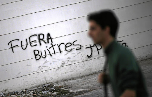 WORDS TO THE WISE: The graffiti in Buenos Aires reads 'vultures, get out' - a reference to hedge funds suing the Argentine government for full repayment of defaulted debt.