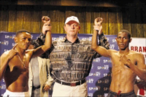 GLADIATORS: Boxing promoter Branco Milenkovic is flanked by South Africa's Silence Mabuza, left, and Colombian Johnny Perez, who will be fighting for the IBF world bantamweight mandatory elimininator at the Springs Indoor Centre, on Friday. 25/05/09. Pic. Mohau Mofokeng. © Sowetan.