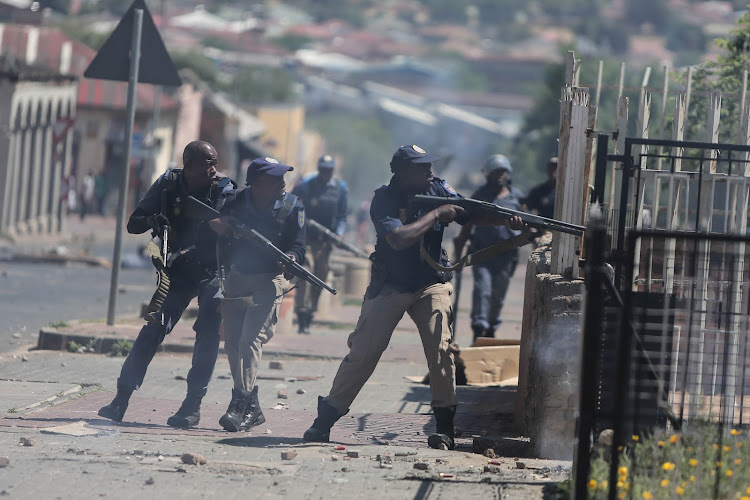 Police fire rubber bullets in an attempt to disperse protesters in Westbury, Johannesburg, on October 1 2018.