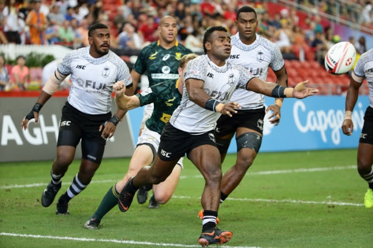 Jerry Tuwai of Fiji makes a pass during the 2018 Singapore Sevens Cup Semi Final match between South Africa and Fiji at National Stadium on April 29, 2018 in Singapore.