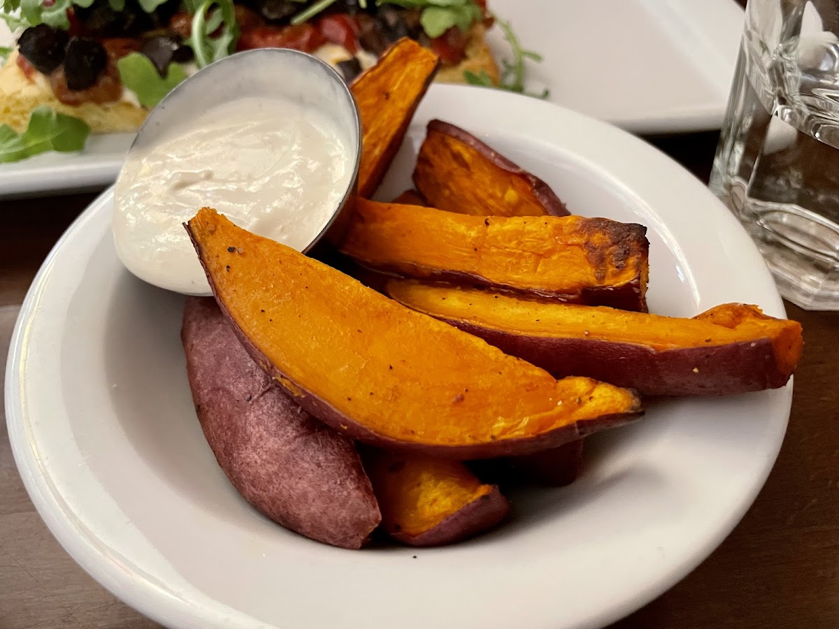 Side of sweet potato wedges with cashew cheese
