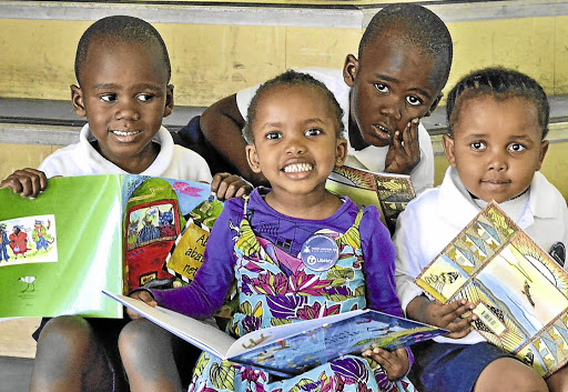 Early start: Preschoolers Sibabalwe, Lisakhanya, Linamandla and Sibusisiwe at the KwaMagxaki library in Port Elizabeth. Once at school, most children in SA do not receive mother tongue education. Picture: IVOR MARKMAN