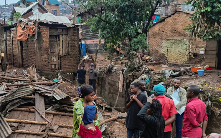 People stand by the damage in the aftermath of deadly floods caused by torrential rains in Bukavu, Democratic Republic of Congo, December 27, 2023.