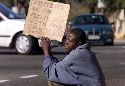 An unemployed young South African pleads for money or food at a Johannesburg street corner.