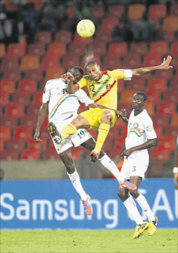 AERIAL BATTLE: Issiakou Koudize of Niger and Seydou Keita of Mali during their Africa Cup of Nations match at the Nelson Mandela Bay Stadium in Port Elizabeth last night. Photo: GALLO IMAGES