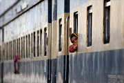 A commuter looks out from a train in Bangladesh. File photo