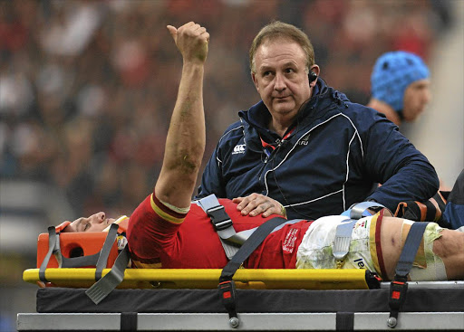 Wales captain and flanker Sam Warburton is taken from the field after picking up an injury during a Six Nations match against England at Twickenham in March last year.