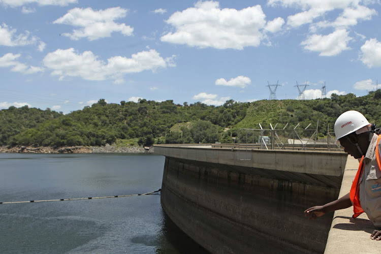 An official of the Zimbabwe Electricity Supply Authority inspects water levels on the Kariba Dam in Zimbabwe. File photo