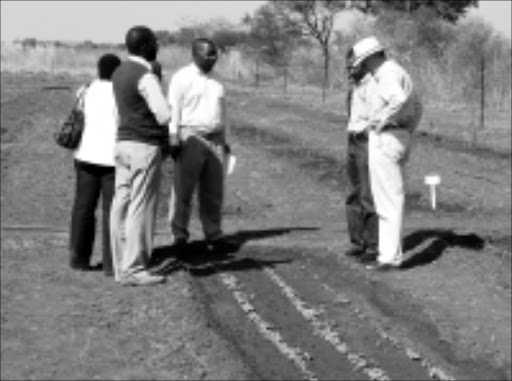 SMALL BEGINNINGS: Ian Daniels, far right, and officials from Limpopo's government departments inspect some of the essential oil-bearing plants at La Boheme farm near Trichardtsdal. Pic. Michael Sakuneka. 08/07/08. © Sowetan.