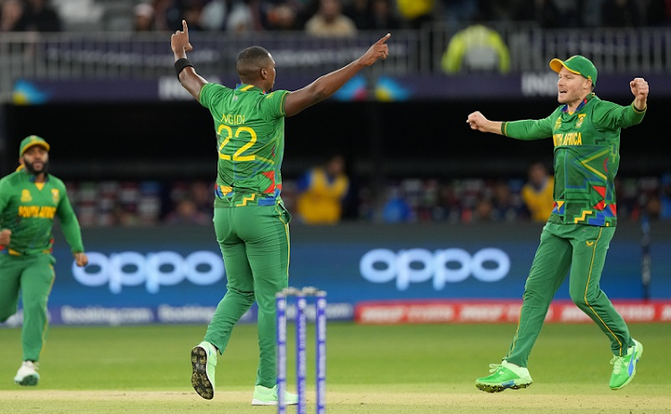 Lungi Ngidi of the Proteas celebrates a wicket with teammate David Miller during the 2022 ICC T20 World Cup match against India at Optus Stadium in Perth on October 30 2022.