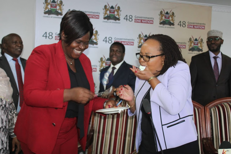 Homa Bay Governor Gladys Wanga and Council of Governors chairperson Anne Waiguru during a surprise birthday cake cutting at the CoG headquarters in Nairobi on April 16, 2024