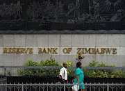 People walk past the Reserve Bank of Zimbabwe building in Harare, Zimbabwe, February 25 2019. 