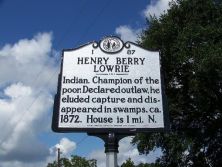 Indian. Champion of the poor. Declared outlaw, he eluded capture and disappeared in swamps, ca. 1872. House 3 mi. NW.Plaque via North Carolina Highway Historical Marker Program, and is used with...