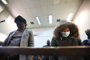 Police officers Scorpion Simon Ndyalvane (left) and Caylene Whiteboy during an earlier appearance at the Protea magistrate's court in Soweto. Ndyalvane had been convicted for two previous crimes.
