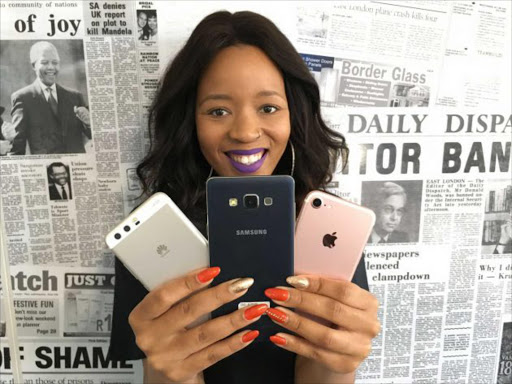 Picture: ALAN EASON IT’S YOUR CALL: Daily Dispatch multimedia reporter Gugu Phandle shows the three most popular mobile phone brands Picture: ALAN EASON