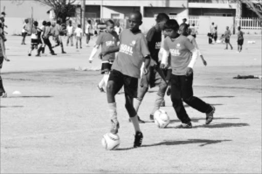 REACHING FOR A DREAM: Hundreds of schoolchildren attended a soccer coaching clinic yesterday in Illovo, Johannesburg, as part of a project supported by former soccer stars to extend access to education for kids from poor backgrounds.Pic: PETER MOGAKI. 23/06/2010. © Sowetan.