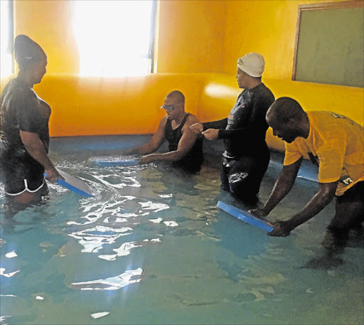 DRIVEN BY PASSION: Good Samaritan Yona Balindlela gives free swimming lessons to 32 Mdantsane pupils, plus some of their teachers, in a move she hopes is also teaching them general water safety Picture: SUPPLIED