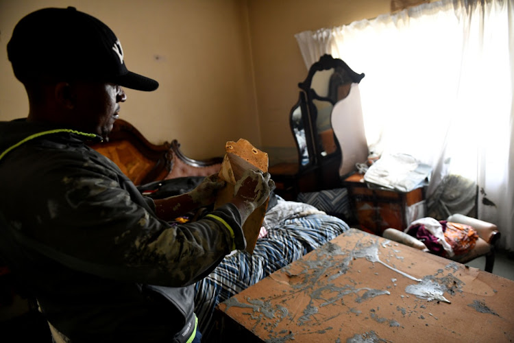 A Jagersfontein resident inspecting documents after a mudslide destroyed homes.