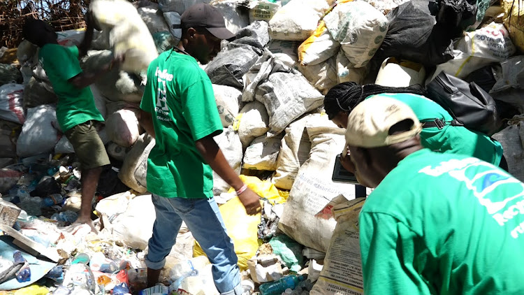 Youth offload plastic waste collected from the ocean and towns at the EcoWorld recycling centre in Watamu, Kilifi county.