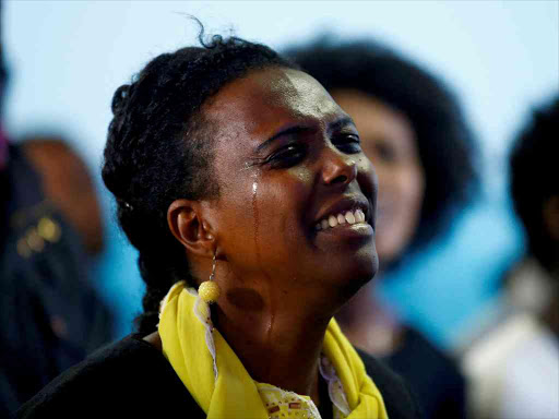A woman cries as she attends a prayer session at Biftu Bole Lutheran Church during a prayer and candle ceremony for protesters who died in the town of Bishoftu a week ago during Ireecha, the thanksgiving festival for the Oromo people, Addis Ababa, Ethiopia, October 9, 2016. /REUTERS