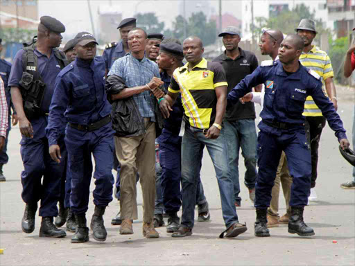Congolese policemen detain opposition activists participating in a march to press President Joseph Kabila to step down in the Democratic Republic of Congo's capital Kinshasa, September 19, 2016. /REUTERS