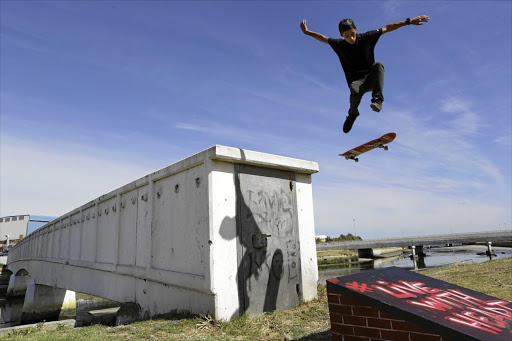 DOGTOWN: Professional skateboarder Jean-Marc Johannes launches himself off the bridge spanning Cape Town's Liesbeek River, in the biggest and most dangerous stunt of his career.