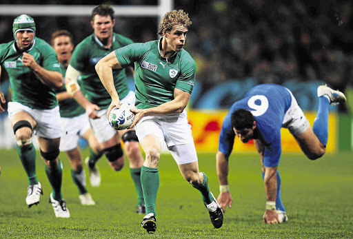 Irishman Andrew Trimble evades an Italian defender and shapes to pass during the pool C match at Dunedin between the two Six Nations rivals yesterday. Ireland won 36-6 Picture: WARREN LITTLE/GALLO IMAGES