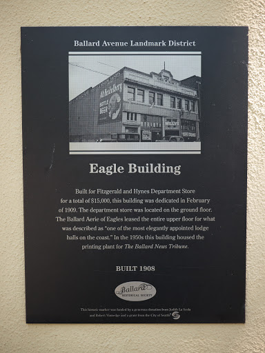 Plaque text: --- Built for Fitzgerald and Hynes Department Store for a total of $15,000, this building was dedicated in February of 1909. The department store was located on the ground floor. The...