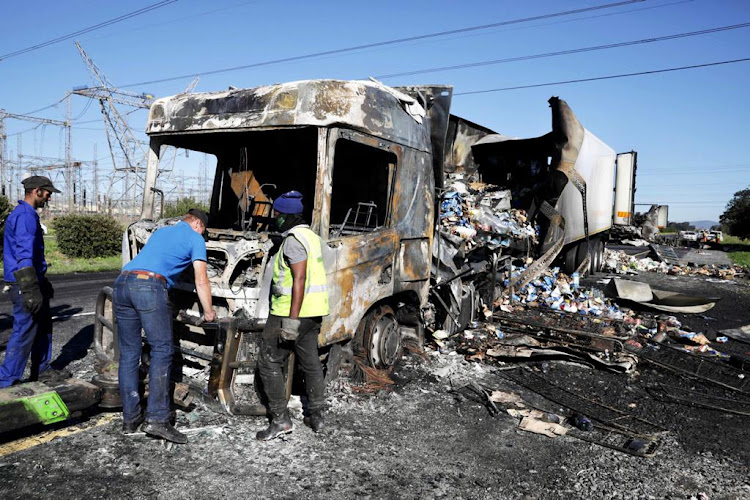 Two trucks, reportedly carrying goods for supermarkets, were set alight on the N1 highway near Cape Town during protests against the employment of foreigners as truck drivers.