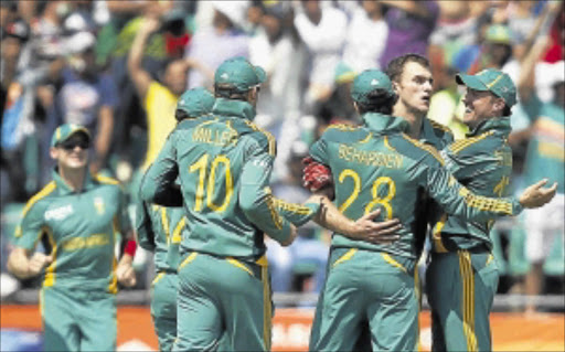 PLAYING CATCH-UP: South Africa's wicketkeeper AB de Villiers, right, celebrates with his teammates after making a catch to dismiss Pakistan captain Misbah-ul-Haq during their final one-day cricket match in Benoni on Sunday. PHOTOS:REUTERS