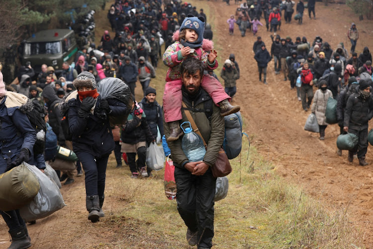 Migrants move towards the Belarus-Poland border in November. Picture: REUTERS/BEITA/OKSANA MANCHUK