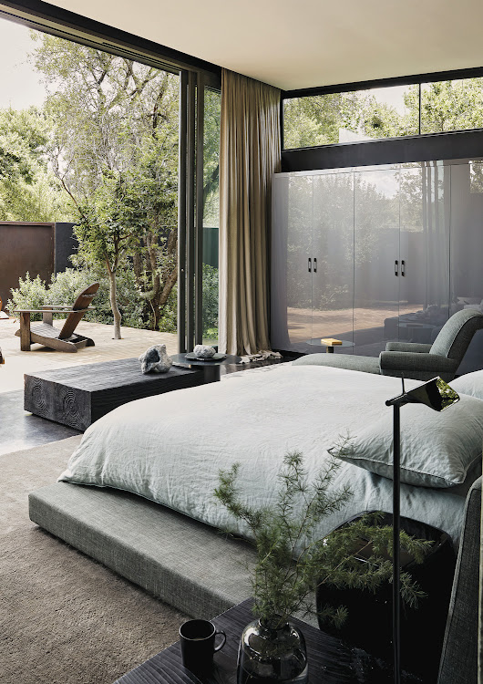 Luxurious and natural elements such as veined green marble, leather, and brass elements blend harmoniously in the main bedroom and its adjoining patio, bathroom, and wardrobe.