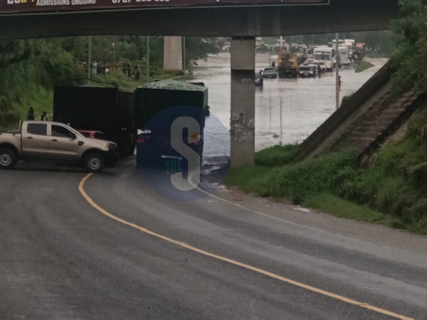 A motorist making u-turn after he was caught up with flood waters along Namanga Road between River - Athi Bridge and Shalom Community hospital in Athi River, Machakos County on April 24/ GEORGE OWITI