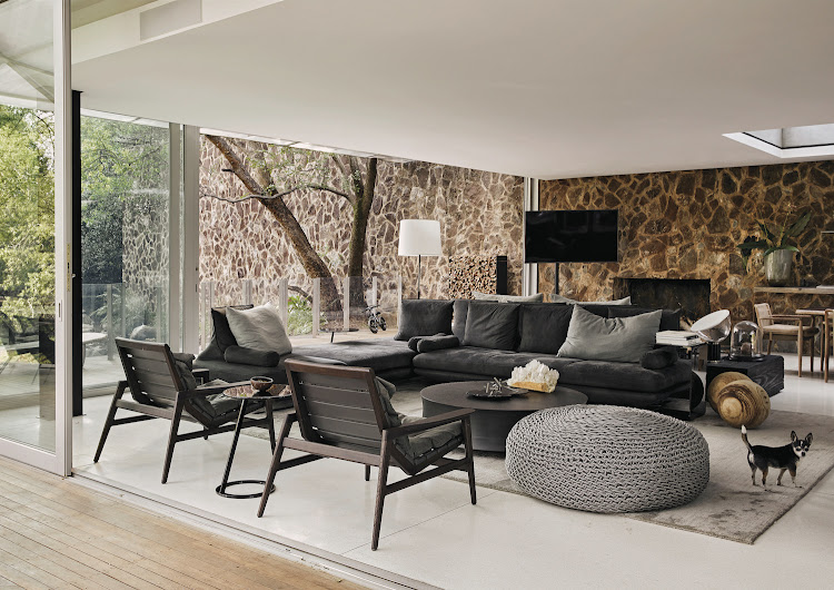 Softer elements such as sofas and armchairs from French furniture brand Ligne Roset have been used in the living areas to contrast with the hi-tech-inspired architecture of the home.