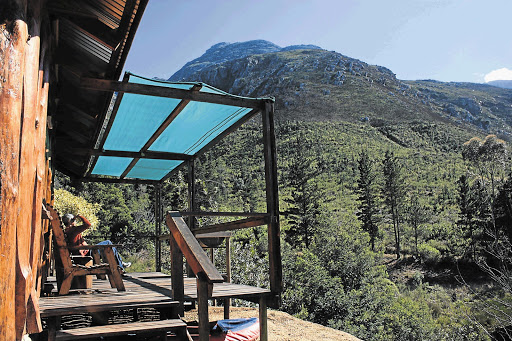 The writer at the log cabin on the neighbouring farm, Fazenda Picture: CHARIS DE KOCK