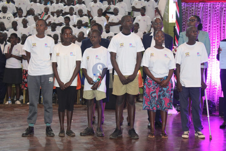 Top beneficiaries line up to receive their scholarships from Education Cabinet Secretary Ezekiel Machogu during the launch of the 2024 Elimu scholarship program at the Bomas of Kenya, Nairobi on January 19, 2023