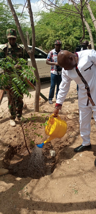 Labour PS Shadrack Mwadime plants a tree at the Garissa county commissioner’s office compound