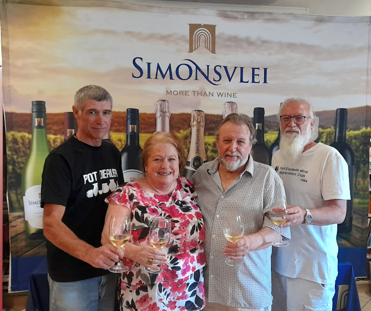 Toasting the PE Wine Appreciation Club’s 40th anniversary, from left, longest-standing member Mark Dodd, club treasurer Debbie Box, cellar master Norman Box and chair Mark Diesel.