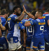 Stormers' captain Siya Kolisi (L) and teammate Dewaldt Duvenage celebrate the try during the Super Rugby match against Blues at DHL Newlands on May 19, 2017 in Cape Town, South Africa.
