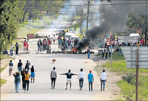 DEMANDING A DECENT LIFE: Keiskammahoek came to a standstill after hundreds of community members blocked the main road with burning tyres yesterday