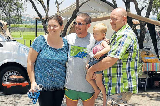 GREAT EFFORT: Tim Stones at the finish of the 48-hour marathon run to help raise funds for two-year-old RW Venter. With him are RW and his mother Stella and father Rudie Picture: SUPPLIED