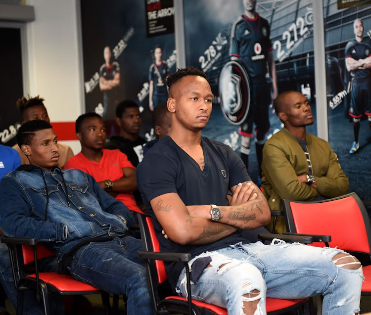 New Orlando Pirates goalkeeper Brilliant Khuzwayo is pictured sitting in front of his fellow Bucs' recruits.